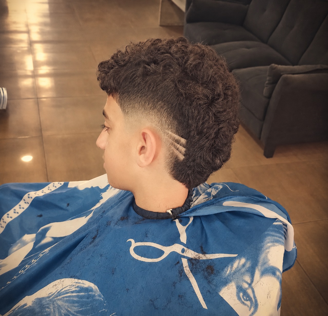 Young man with a buzz cut and a creative wave design shaved in